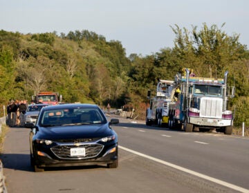 Emergency responders gather near the scene of a fatal bus crash, in Wawayanda, N.Y., Thursday, Sept. 21, 2023. A charter bus carrying high school students to a band camp hurtled off a New York highway and down an embankment, officials said. (AP Photo/Adam Hunger)