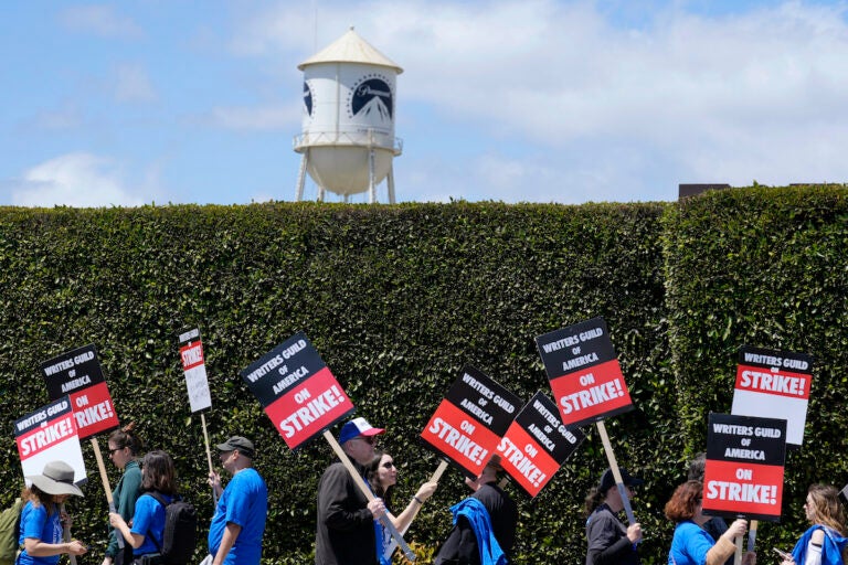 Striking writers take part in a rally in front of Paramount Pictures studio, Tuesday, May 2, 2023, in Los Angeles. A tentative deal was reached, Sunday, Sept. 24, 2023, to end Hollywood’s writers strike after nearly five months.