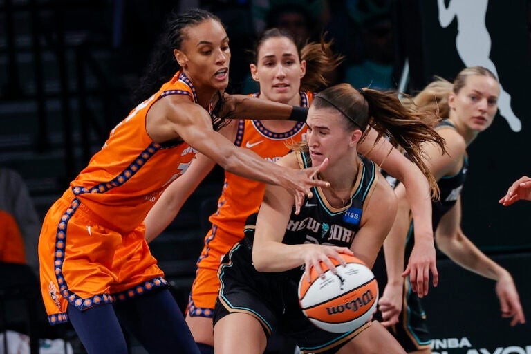 New York Liberty guard Sabrina Ionescu, front right,is defended by Connecticut Sun forward DeWanna Bonner, left, during the second quarter of a WNBA basketball game, Sunday, Sept 24, 2023, in New York. (AP Photo/Eduardo Munoz Alvarez)