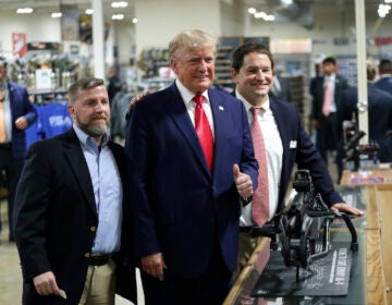 Former President Donald Trump visits the Palmetto State Armory and takes a picture with owners Jamin McCallum and Julian Wilson in Summerville, S.C., Monday, Sept. 25, 2023.