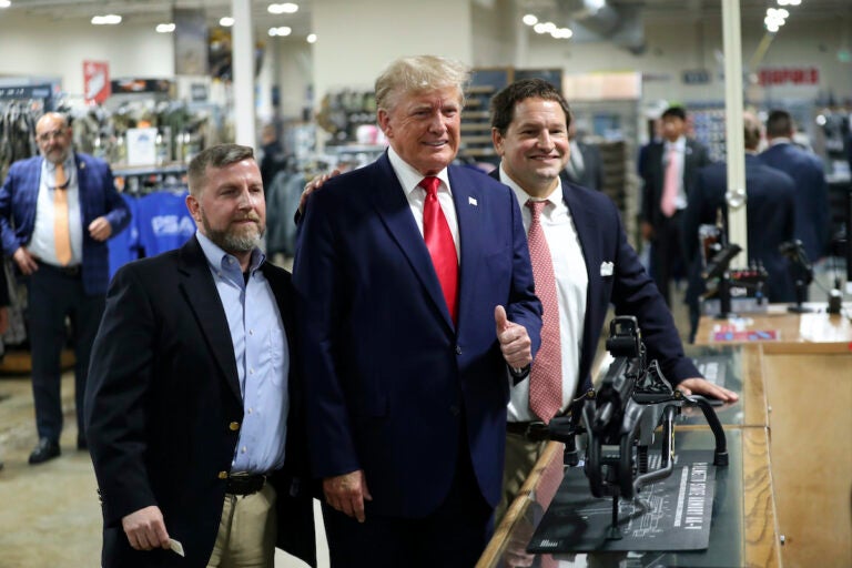 Former President Donald Trump visits the Palmetto State Armory and takes a picture with owners Jamin McCallum and Julian Wilson in Summerville, S.C., Monday, Sept. 25, 2023.