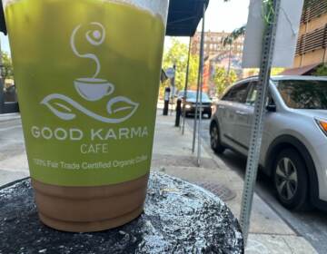 Coffee cup from Good Karma Cafe sitting on a table.