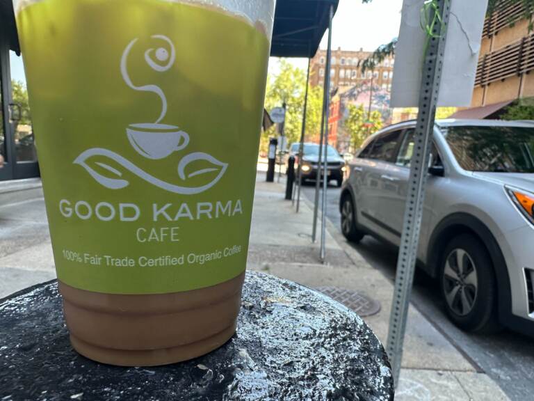 Coffee cup from Good Karma Cafe sitting on a table.