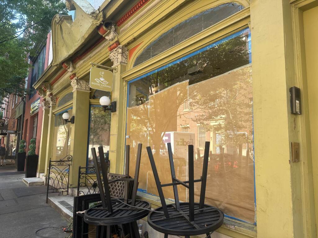 A closed up shop, with boarded-up windows