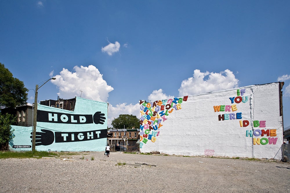 2 large murals on the side of neighboring buildings