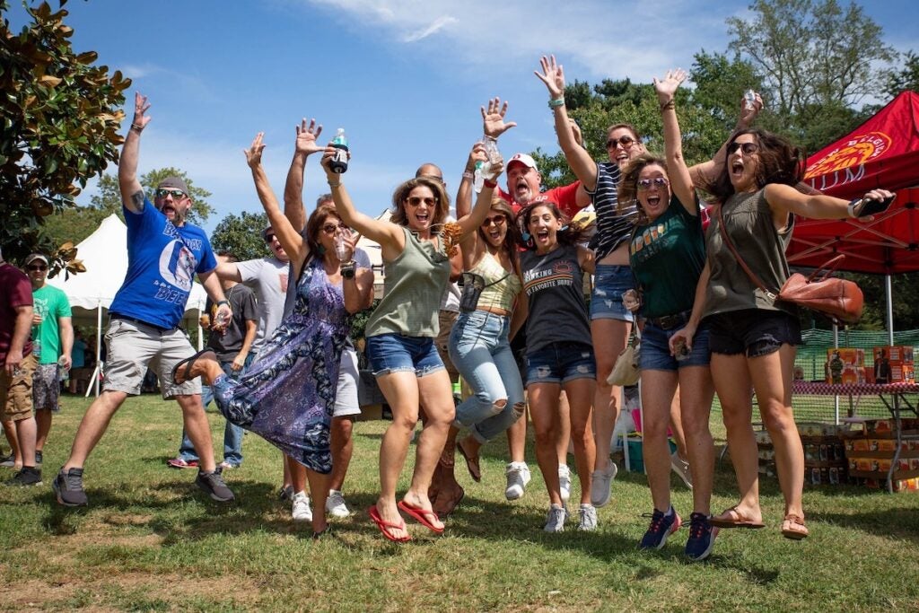 A group of people jump while posing for a photo