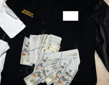 A jacket bearing Menendez's name, along with cash from envelops found inside the Jacket during a search by federal agents of the senator's home in Harrison