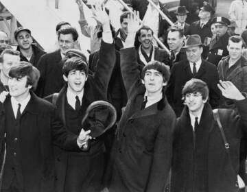 The Beatles waving to fans in 1964