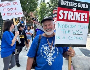 Brian Nelson holding a sign at the picket line