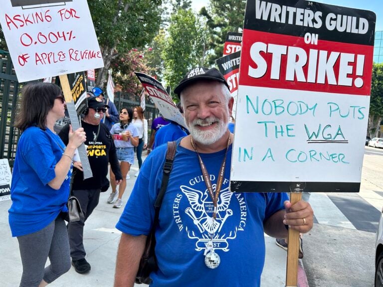 Brian Nelson holding a sign at the picket line