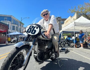 Dick Miles poses on a motorcycle