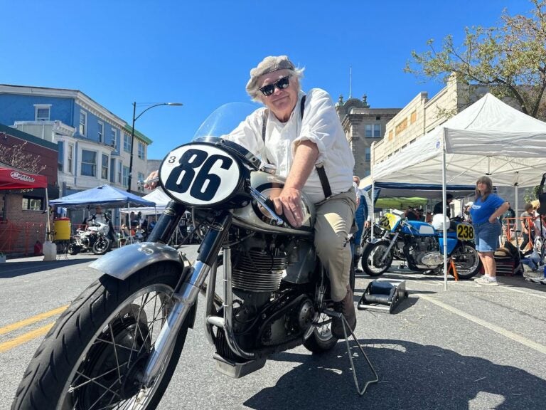 Dick Miles poses on a motorcycle