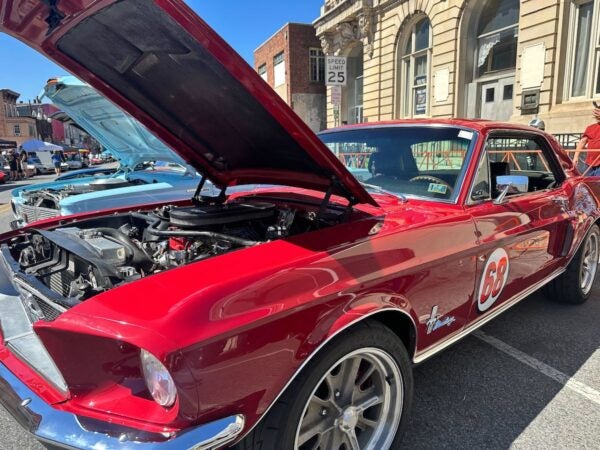 A red car with the hood propped open