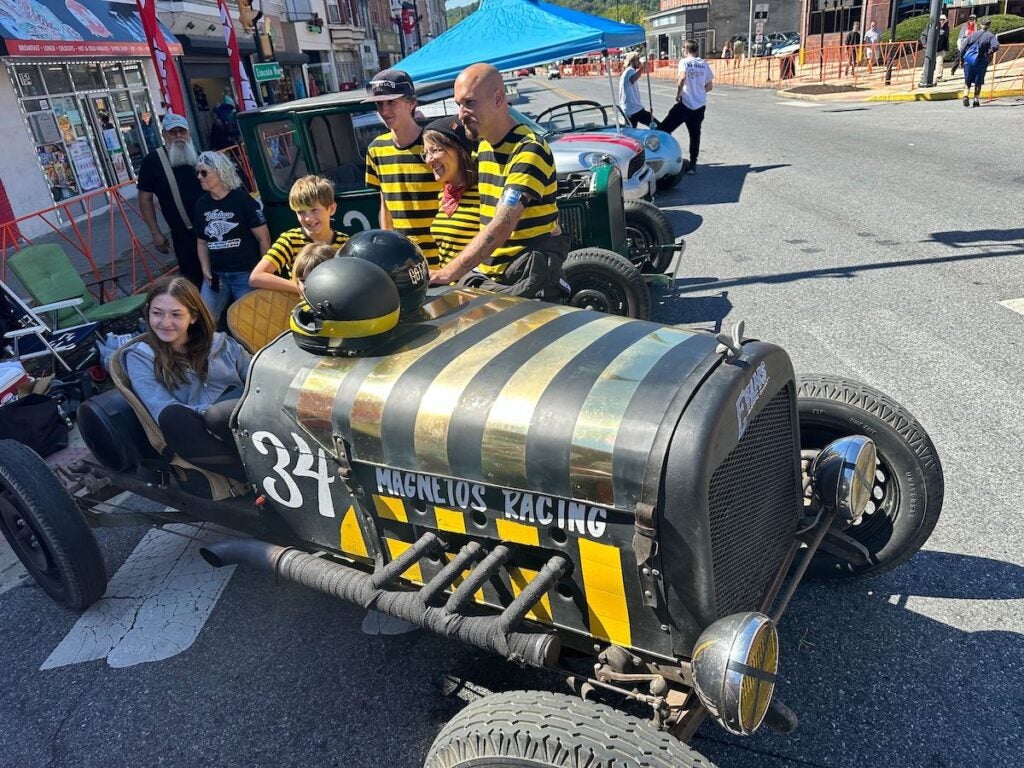 Jon Keesey and his family pose with a bee-themed 1930-era car.