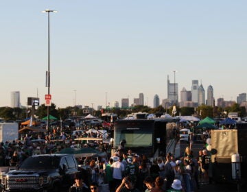Eagles fans in the foreground, the Philly skyline visible in the background.