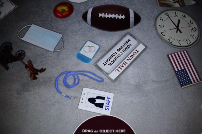 Objects in an interactive exhibit at the First Amendment gallery, including a football, a clock, and a U.S. flag.