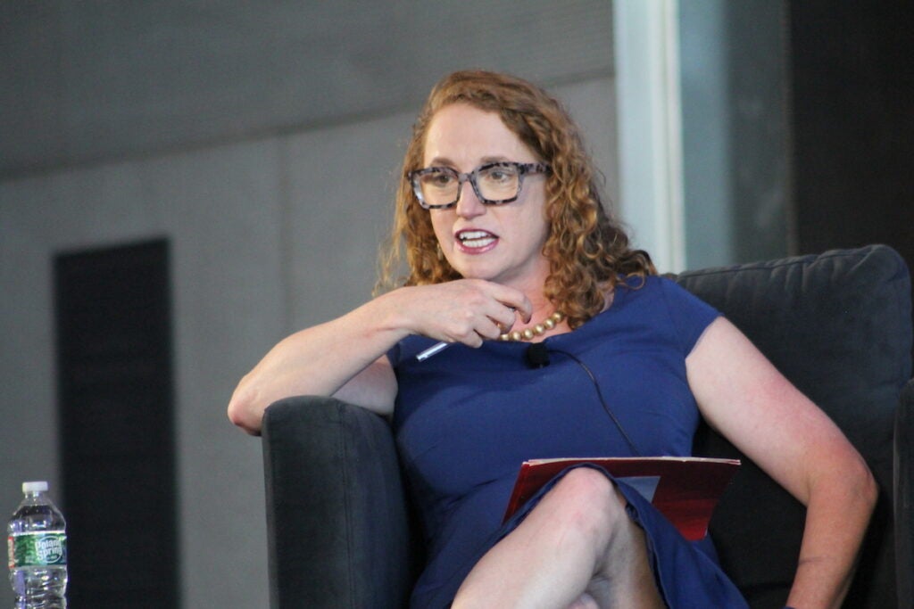 Suzanne Nossel speaks while seated onstage.