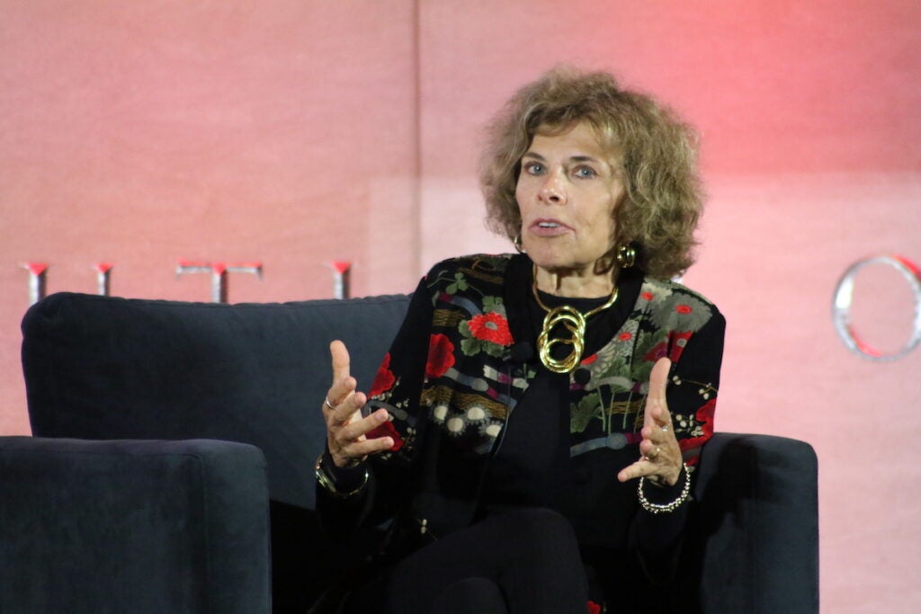 Nadine Strossen gestures as she speaks while seated onstage.