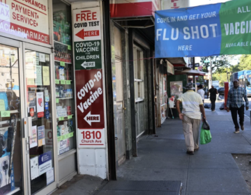 Pharmacy with signs advertising COVID tests and vaccines