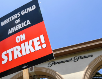 A closeup of a sign says ''Writers Guild of America on strike''