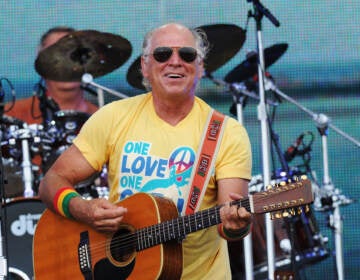 Musician Jimmy Buffett performs onstage at Jimmy Buffett & Friends: Live from the Gulf Coast, a concert presented by CMT at on the beach on July 11, 2010 in Gulf Shores, Alabama. (Rick Diamond/Getty Images for CMT)
