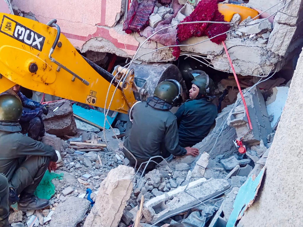 Rescue workers search for survivors in a collapsed house in Moulay Brahim, in Morocco's Al Haouz province, on Saturday after an earthquake.