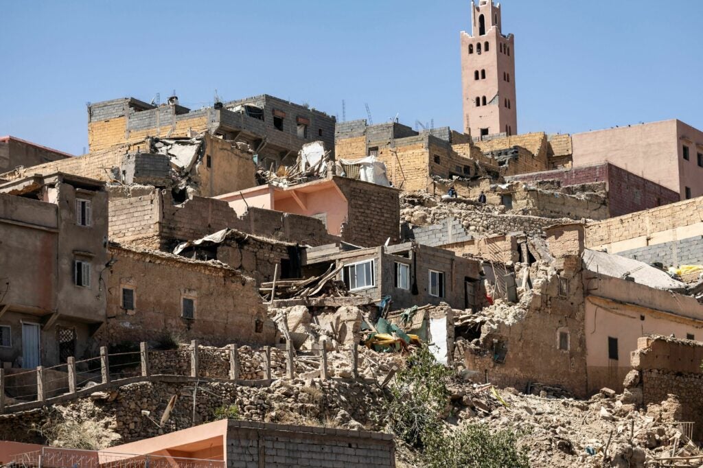 The minaret of a mosque stands behind damaged or destroyed houses following an earthquake in Moulay Brahim, Al-Haouz province, on Saturday.