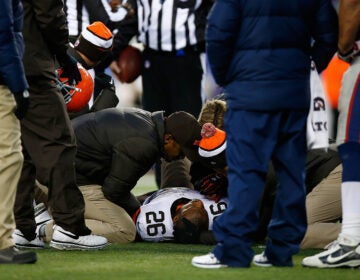 Willis McGahee, No. 26 of the Cleveland Browns, is tended to on the field in the fourth quarter of a game against the New England Patriots at Gillette Stadium in Foxboro, Mass., on Dec. 8, 2013,