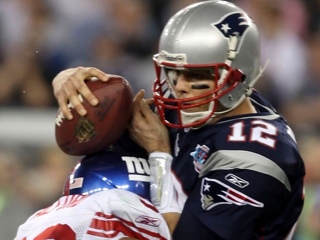 Defensive tackle Jay Alford of the New York Giants sacks quarterback Tom Brady, No. 12, of the New England Patriots for a 10-yard loss in the final minute of Super Bowl XLII on Feb. 3, 2008, at the University of Phoenix Stadium in Glendale, Ariz.