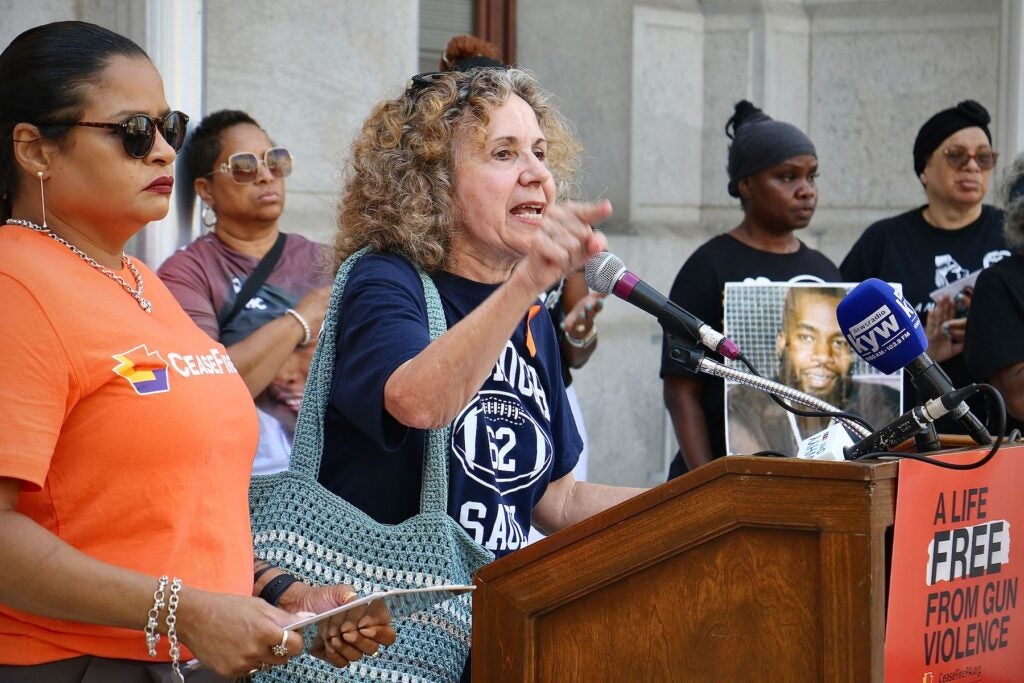 Marge LaRue speaking at a podium