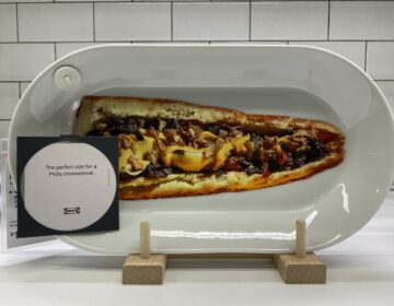 A plate at Ikea with a cut-out image of a cheesesteak