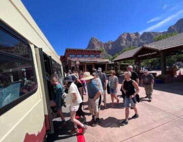 Tourists board a shuttle in Zion Naitonal Park.