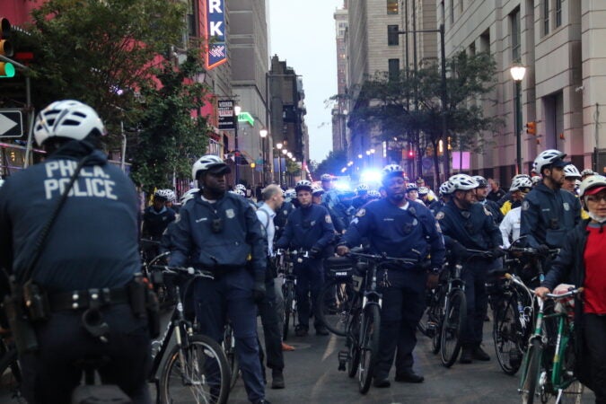 Police officers standing next to bikes in Center City.