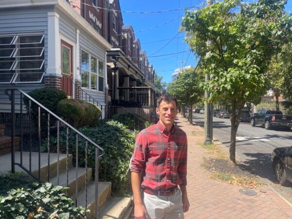 Jason Hoover standing on the sidewalk in front of his house