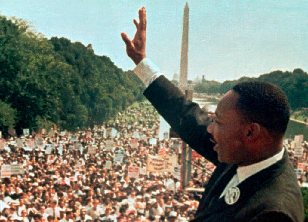 Martin Luther King, Jr. waves to the crowd at the March on Washington in 1963