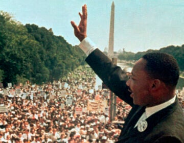 Martin Luther King, Jr. waves to the crowd at the March on Washington in 1963