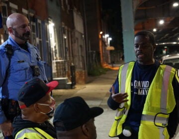 Emmanuel Bussie speaks to a group of volunteers.