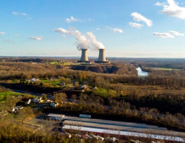 A power plant is seen in the distance.