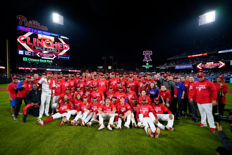 The Philadelphia Phillies pose after clinching a wild-card playoff spot, Tuesday, Sept. 26, 2023, in Philadelphia.