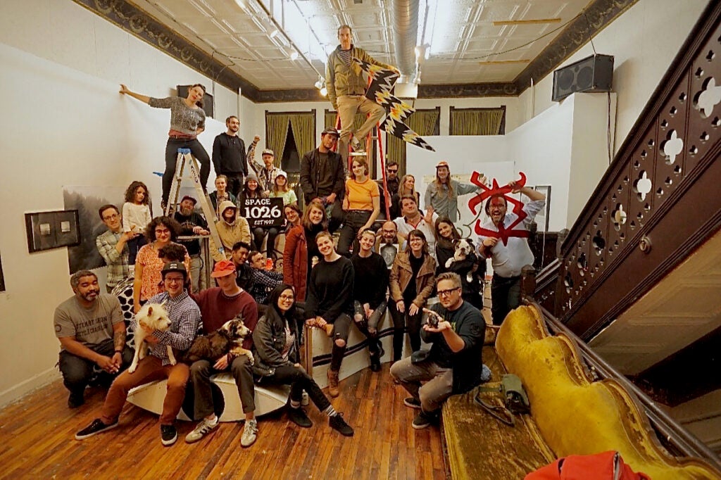 Members of an artist collective pose together for a photo.