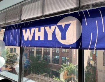 WHYY banner hanging in a window of an office