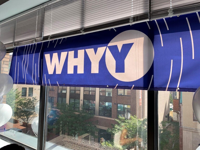 WHYY banner hanging in a window of an office