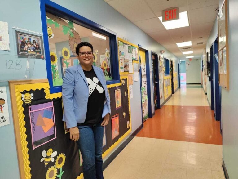 Dr. Michelle Carerra Morales poses for a photo in a hallway