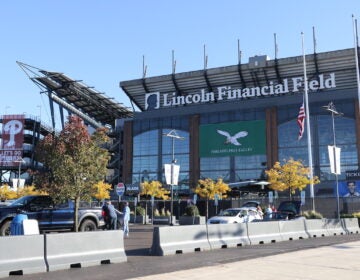 The Philadelphia Eagles home stadium, Lincoln Financial Field, has a banner rooting for their neighbors across the street. (Cory Sharber/WHYY)