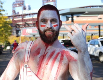 Mike Grimm is a lifelong Phillies fan who says the atmosphere at Citizens Bank Park can't be matched. He dyed his hair red on Monday ahead of Game 6 of the National League Championship Series. (Cory Sharber/WHYY)