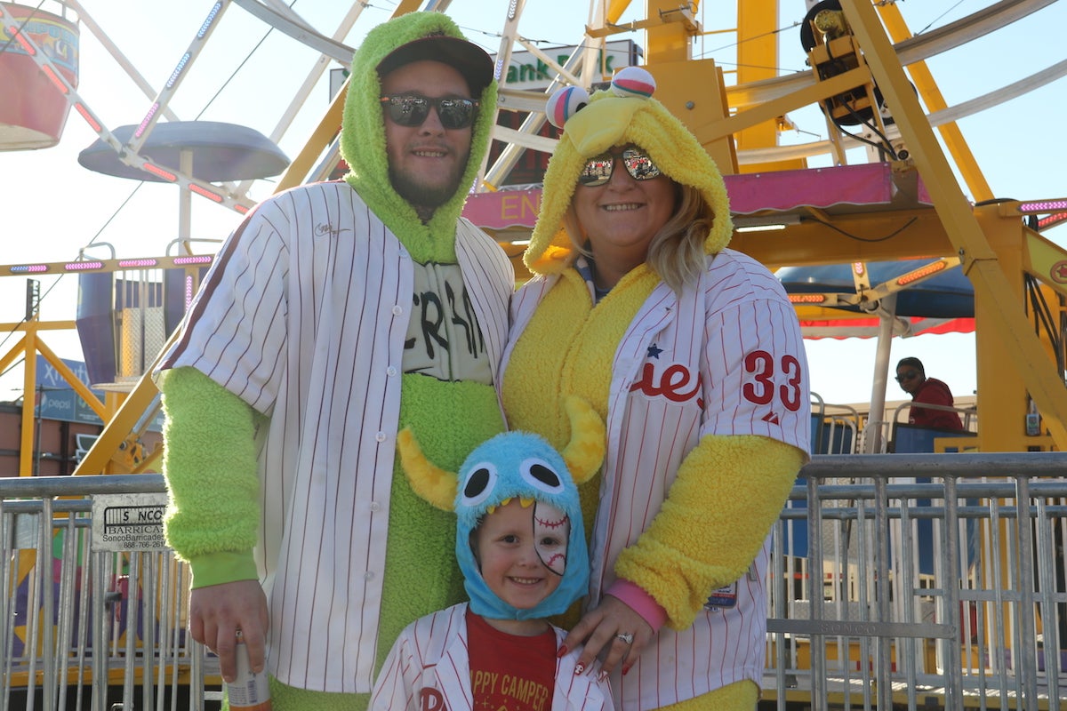 The Wolhafes (Dax, Brooke, and Dax John) were feeling festive with all of the activities set up outside Citizens Bank Park for the National League Championship Series. (Cory Sharber/WHYY)