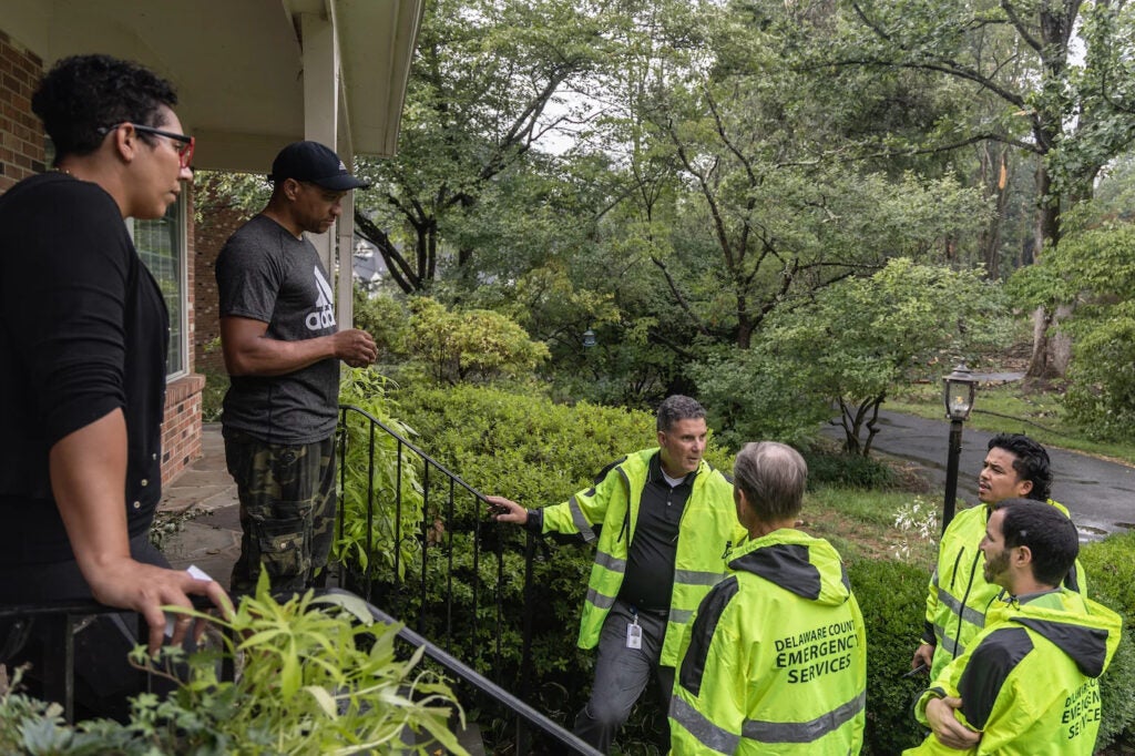 Cat and Robert Tucker (left) talk with Chadds Ford director of emergency services Tim Boyce (center) about the estimated cost of tree cleanup from a storm that took down many trees on their property in August, 2023