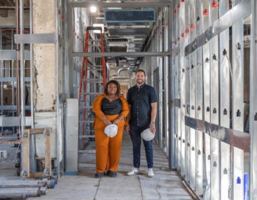 Tia Hall, left, and Alex Robles, right, pose for a photo in the building that will serve as the new home of El Centro de Estudiantes