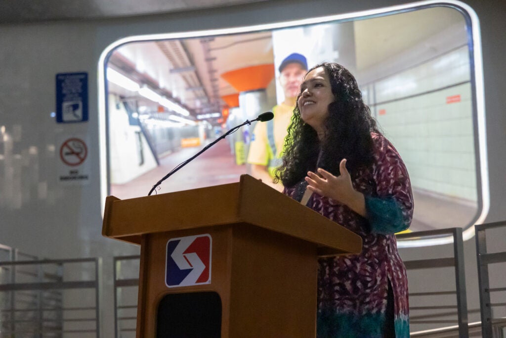 Anula Shetty speaking at a podium