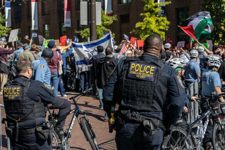 Police officers watch the rally